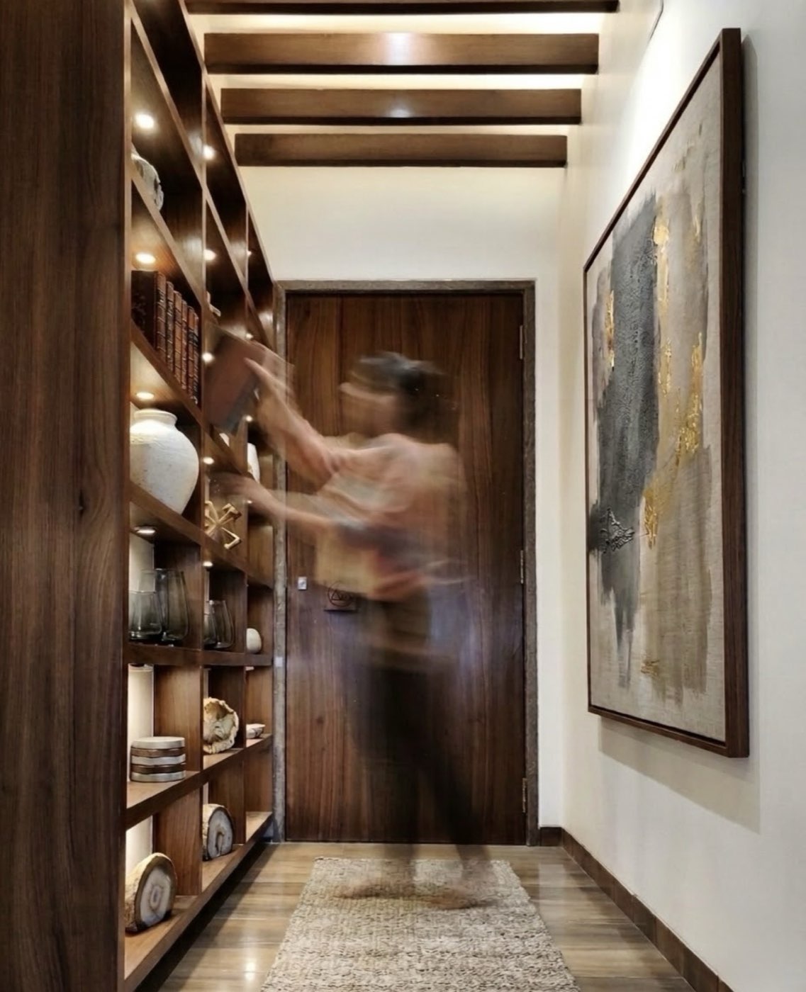 Gallery hallway with custom shelving and abstract art