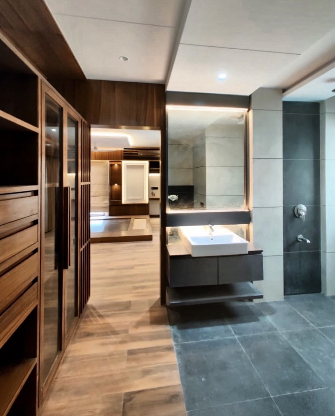 Walk-in closet opening to a marble bathroom